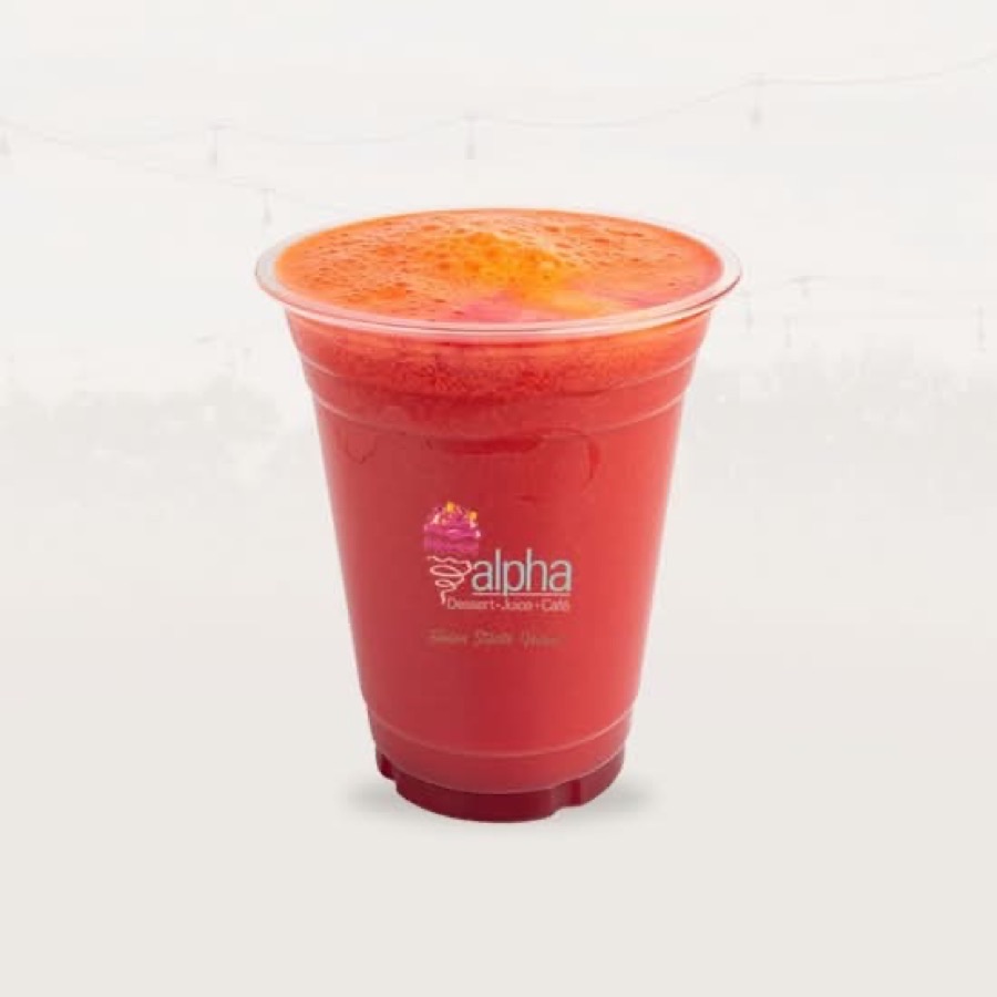 A fresh-pressed juice in an Alpha Cafe cup
