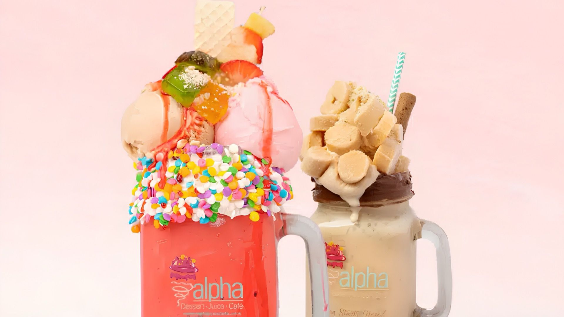 Two loaded Alpha Cafe milkshakes topped with ice cream, sprinkles and wafers